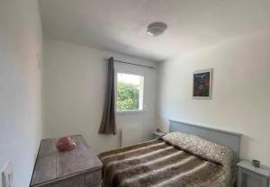 a bedroom with a bed and a window in it at Kirollos in Montlhéry
