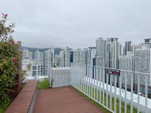 a balcony with a view of a city with tall buildings at Stay in Waves in Ch'ŏngsap'o