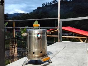 a bucket on a balcony with a view of a mountain at Las Margaritas Cabin in Chinchiná +6 photos