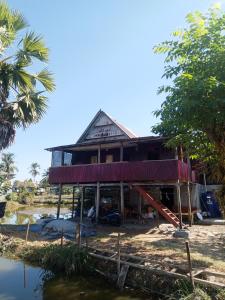 a house on the shore of a body of water at Jufri Homestay in Kasijala +20 photos