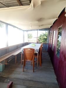 a table and chairs on the porch of a house at Jufri Homestay in Kasijala