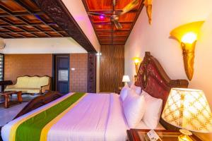 a bedroom with a large bed in a room at Clifinn Wellness Beach Resort by nutmeg in Trivandrum