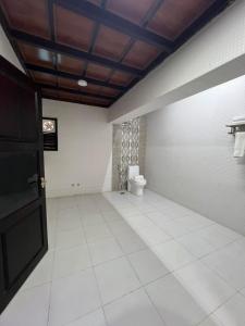 a bathroom with a toilet in a room at Clifinn Wellness Beach Resort by nutmeg in Trivandrum +33 photos