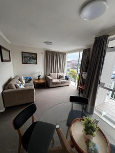 a living room with a table and a couch at Methven Mountain View Apartment in Methven