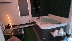 a bathroom with a tub with a toilet and a sink at Berwyn Alimot Proshortlet-home LLC in Syracuse +28 photos