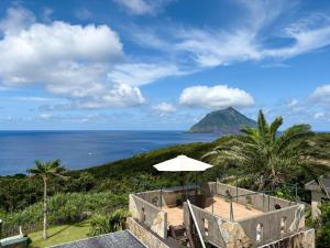 a view of the ocean from a resort with an umbrella at Green Post - Vacation STAY 21855v in Yaene