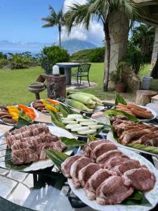 a table topped with meats and vegetables on a table at Green Post - Vacation STAY 21855v in Yaene