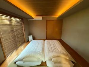 a large bed in a bedroom with a window at Green Post - Vacation STAY 21855v in Yaene