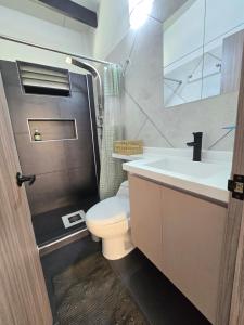 a bathroom with a toilet and a sink and a shower at Chalet - ENCANTO - Donde la Tranquilidad tiene la mejor Vista in El Cerrito