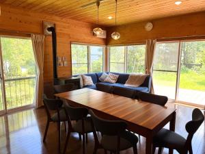 a living room with a wooden table and a couch at Asu base Yuge in Hachimantai