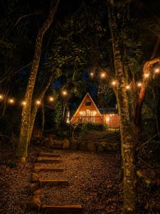 a cabin at night with lights in the trees at Cabana Cipó in Passo Fundo +7 photos