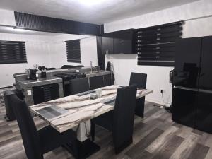 a kitchen with a table and chairs in a kitchen at Black House in Anasco +3 photos