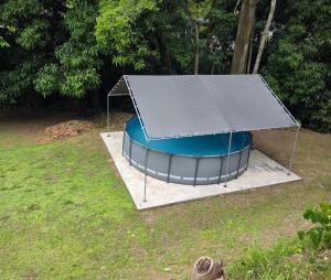a trampoline with a black cover on a field at Black House in Anasco