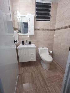 a bathroom with a toilet and a sink at Black House in Anasco
