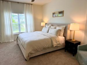 a bedroom with a large bed and a window at StarkVilla - The Perfect Location! in Starkville