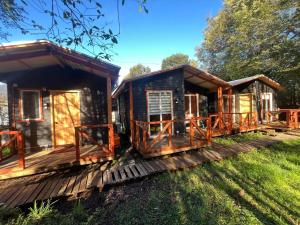 a cabin in the woods with wooden decks at Cabañas Villegas C2 in Hornopiren