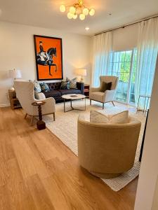 a living room with a couch and chairs at StarkVilla - The Perfect Location! in Starkville