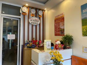 a restaurant with clocks on the wall and a counter at An's Home in Hanoi