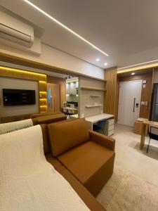 a large living room with a couch and a desk at Studio Mandarim Campolim in Sorocaba +46 photos