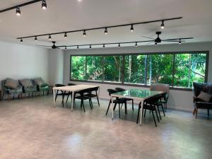 a room with tables and chairs and large windows at The Regent Phuket Bangtao Beach in Bang Tao Beach +183 photos