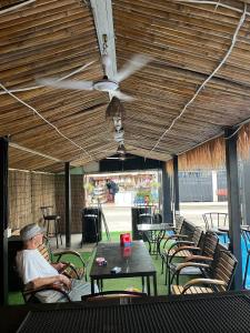 a man sitting in a chair at a table at White Castle in Siem Reap