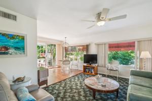 a living room with a couch and a table at Banyan House Vacation Rentals in Venice