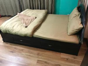 a bed with a pillow on top of it at Konjyosom Homestay-Experience Real Nepali Hospitality in Kathmandu +2 photos