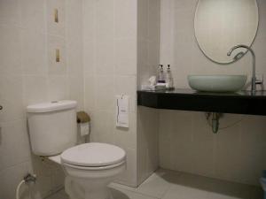 a bathroom with a white toilet and a sink at Sabai @ Chumphae Hotel in Chum Phae +28 photos