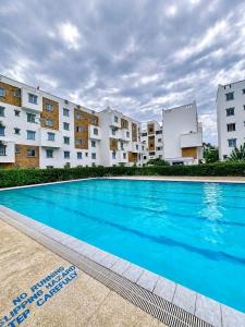 a large swimming pool in front of some buildings at JKIA Prestige kenya in Nairobi