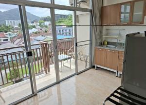 a kitchen with a view of a balcony at U Sabai Living Hotel in Patong Beach