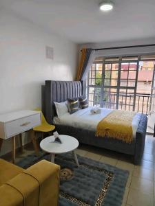 a bedroom with a large bed and a living room at JKIA Prestige kenya in Nairobi +20 photos