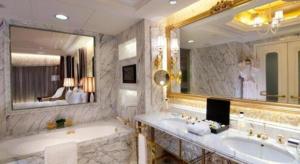 a bathroom with a sink and a large mirror at L'Arc Hotel Macau in Macau