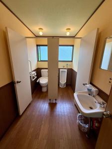a bathroom with a toilet and a sink at Guest house AZSINN in Ueda