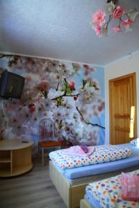 a bedroom with a painting of flowers on the wall at Algida House in Druskininkai