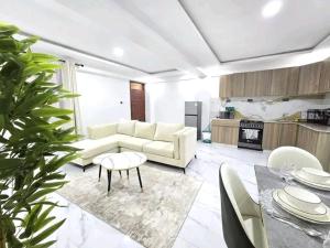 a living room with a couch and a table at JKIA Prestige kenya in Nairobi