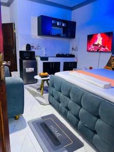 a bedroom with a bed with a couch and a stove at JKIA Prestige kenya in Nairobi