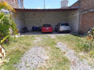 a garage with two cars parked in it at Hostal, casa Jaramillo in Roldanillo