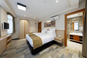 A bed or beds in a room at Nishant Hotel
