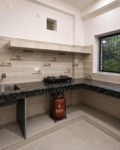 a kitchen with a sink and a counter top at PRANSHI HOMe STAY in Deoghar