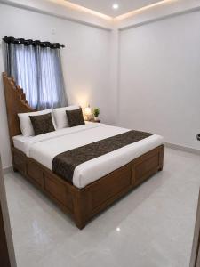 a bedroom with a large bed in a room at PRANSHI HOMe STAY in Deoghar