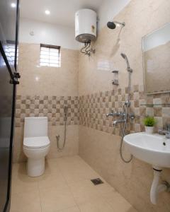 a bathroom with a shower and a toilet and a sink at PRANSHI HOMe STAY in Deoghar