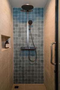 a bathroom with a shower with blue tile at Sea Salt Stay Samui in Nathon +84 photos