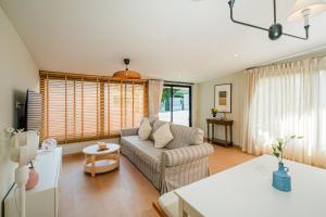 a living room with a couch and a table at Sea Salt Stay Samui in Nathon