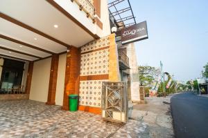 a building with a sign on the side of it at Bintang Samudra Hotel in Jepara