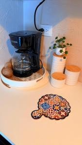 a coffee maker sitting on a counter next to a plate at Villa Yasmín - Apartamento Top in Villa Canales