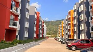 a row of buildings with cars parked on a street at Villa Yasmín - Apartamento Top in Villa Canales