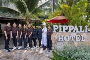 a group of people standing in front of a hotel at Pippali Boutique Hotel in Kampot +111 photos