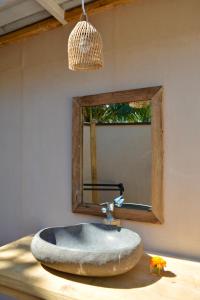a bathroom with a sink and a mirror at MaoMeno Yoga Resort in Gili Meno