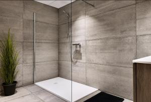 a shower with a glass door in a bathroom at Eh ma biche in Stoumont