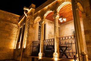 a stone building with a balcony at night at la mar cave cappadocia in Ürgüp